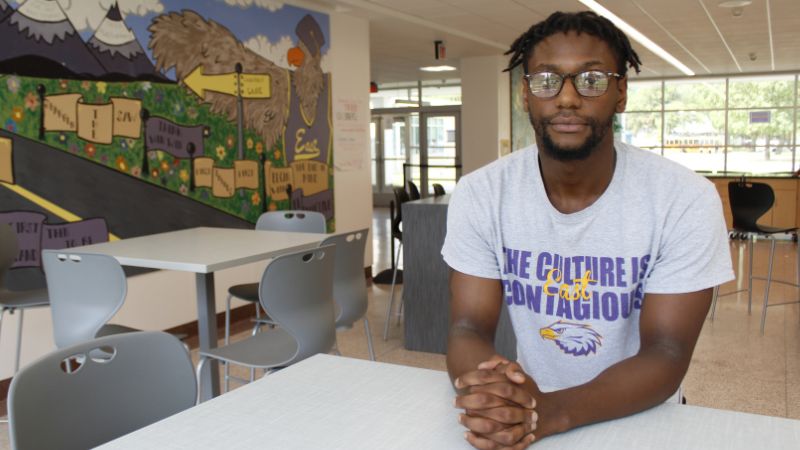 James Jones a teacher at East High School poses in a common space at the school