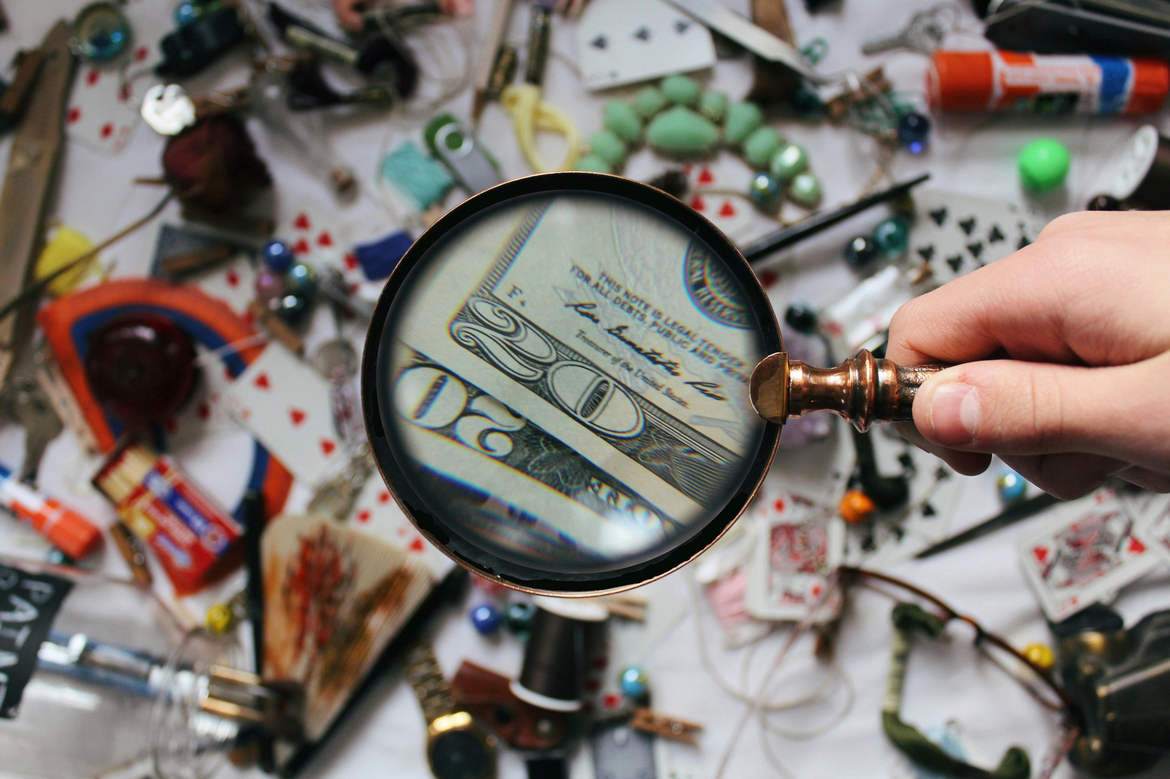 Magnifying glass looking at money