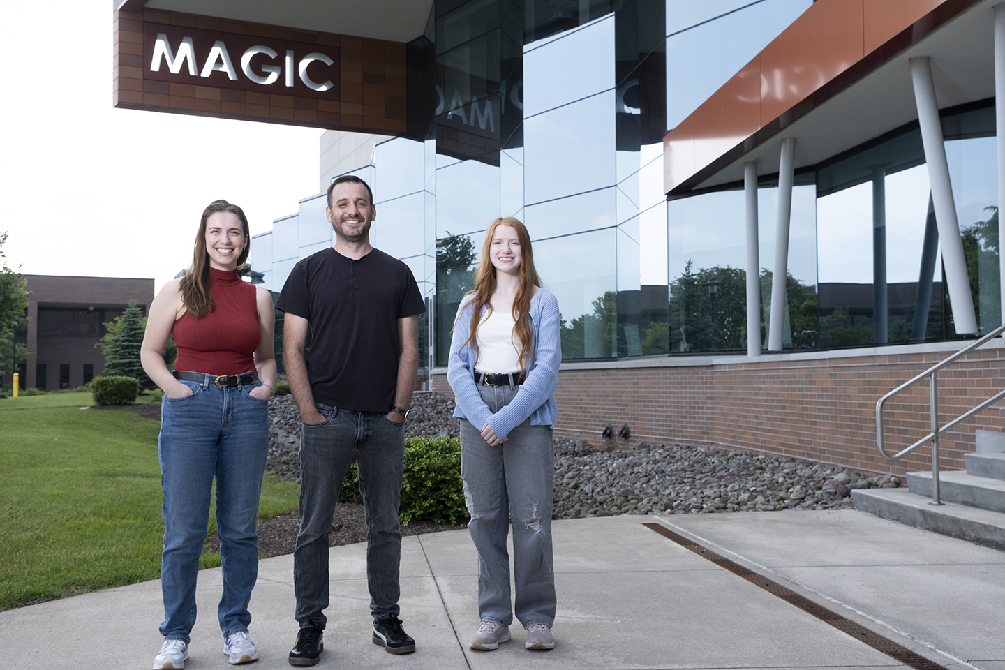 Animation faculty and students pose for a portrait outside MAGIC Spell Studios.