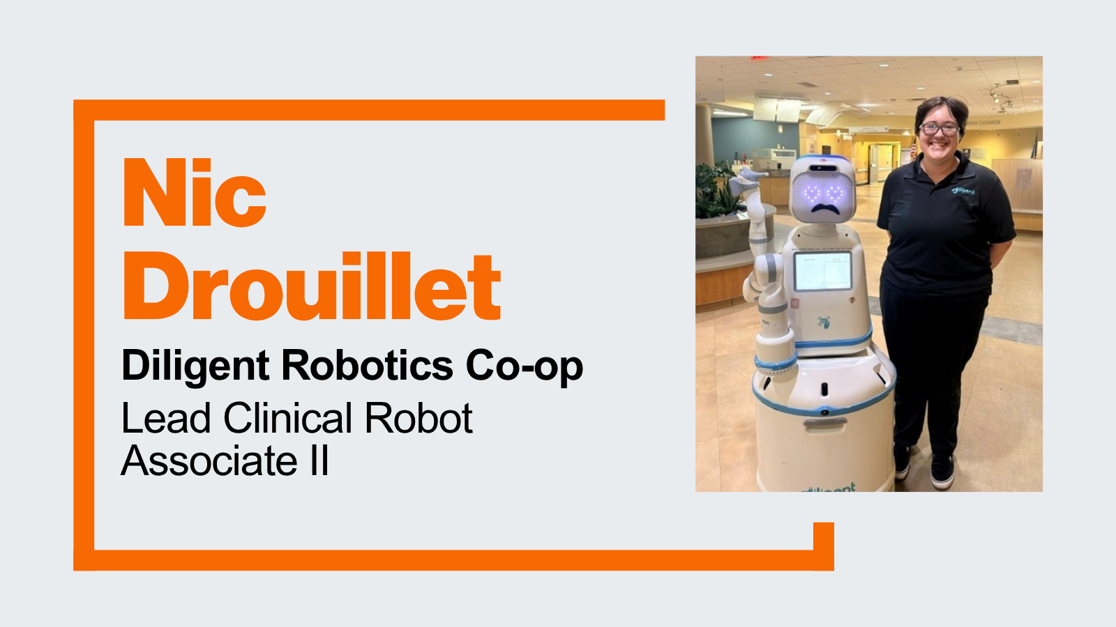 student Nic Drouillet standing beside Moxi, a robot assistant