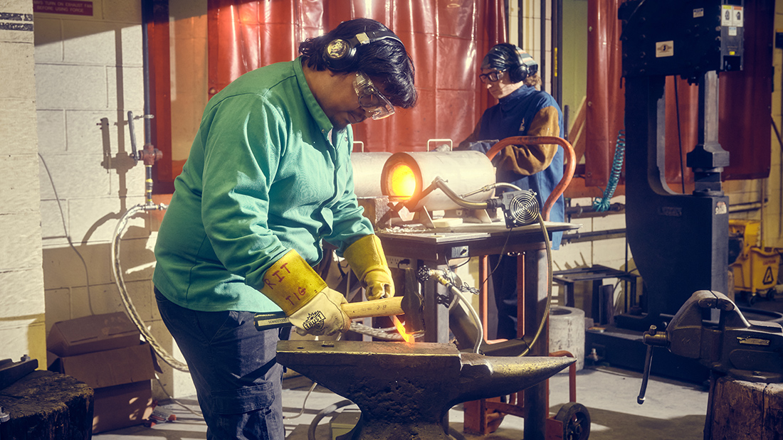 Student work in the foundry during a steel forging class.