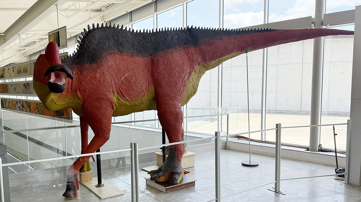 A 19-foot dinosaur sculpted by an RIT sculpture student stands in Ithaca's Museum of the Earth.