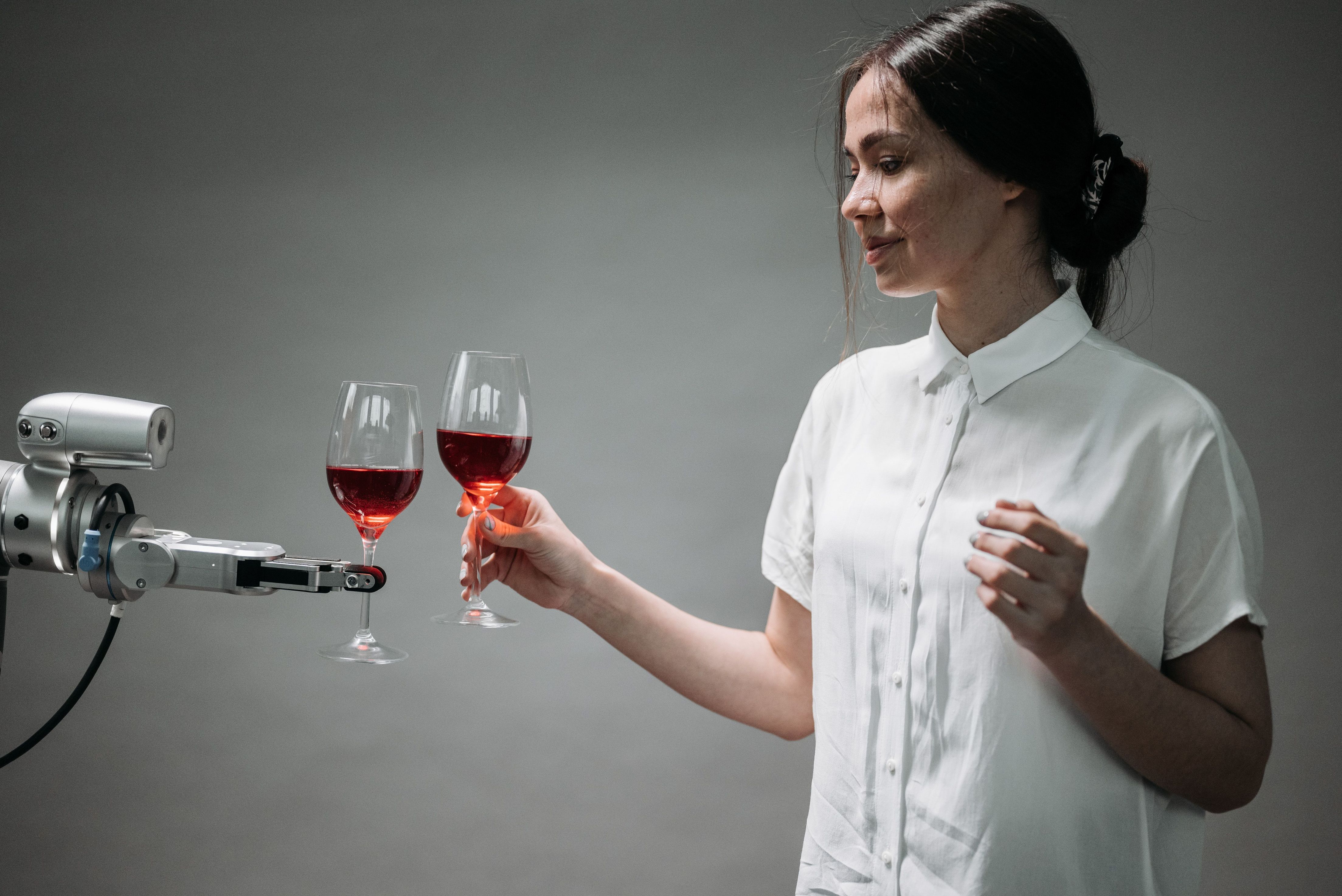 robot giving woman a glass of wine