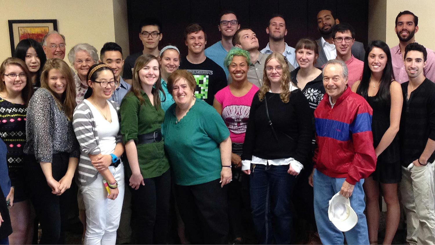 a large group photo of college students and older adults.