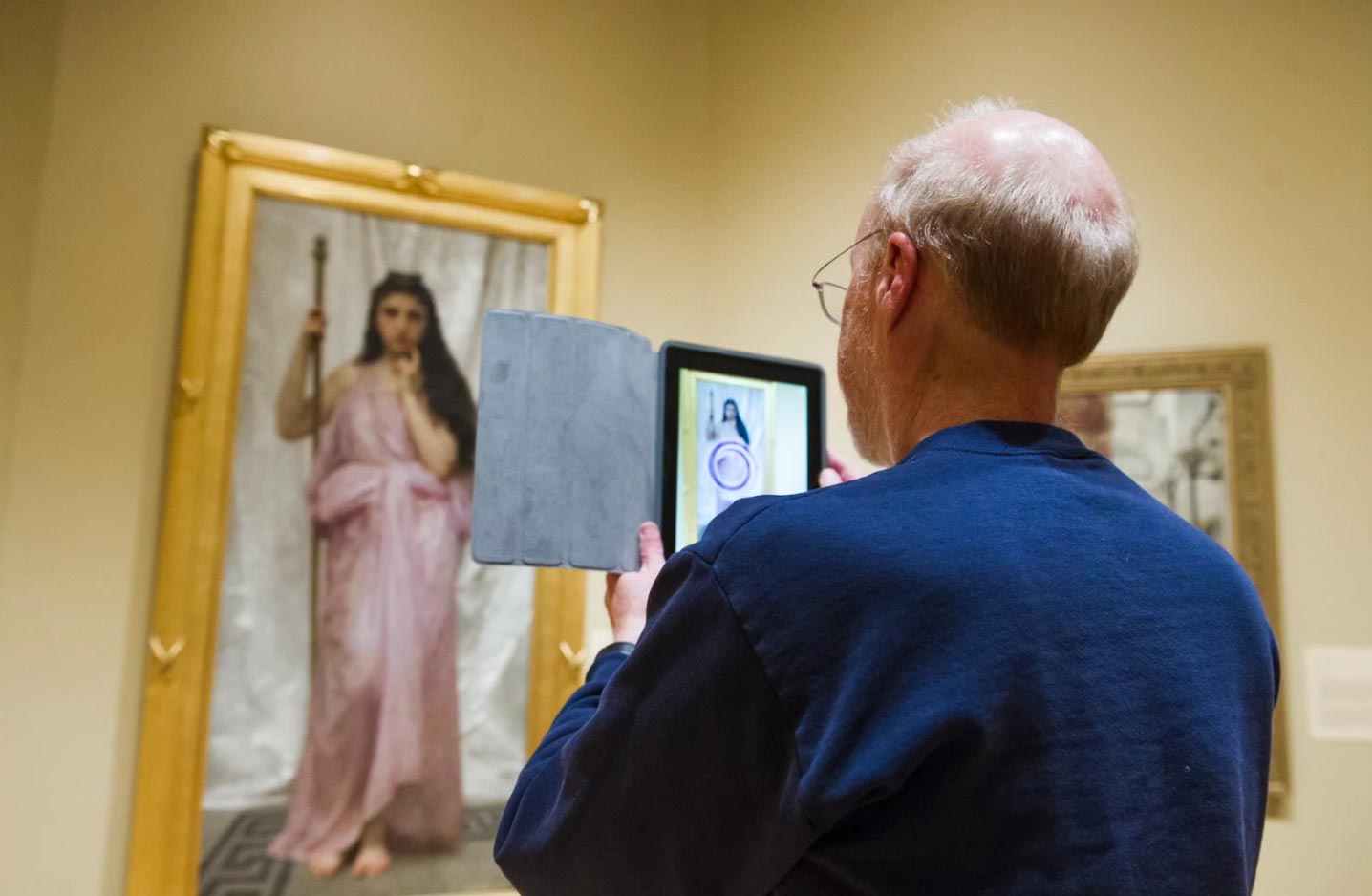 person takes a photo of a painting of a woman in a gallery.