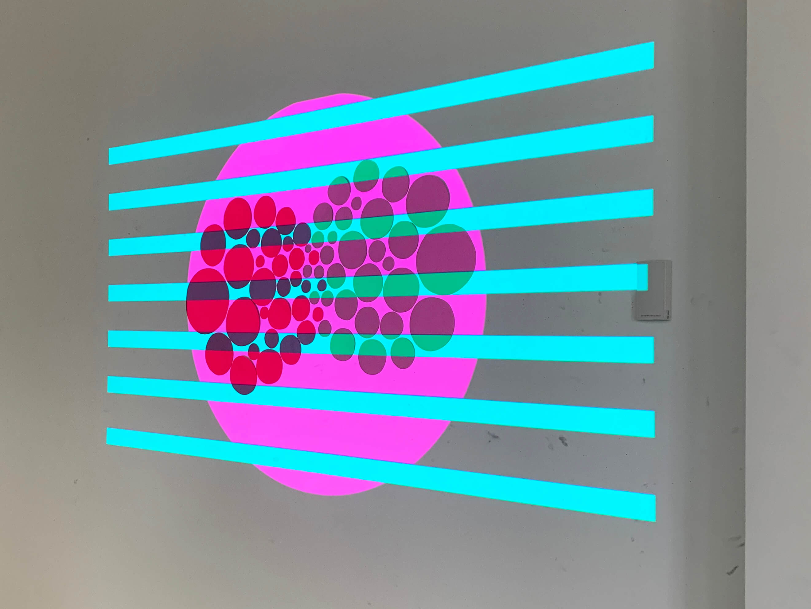 horizontal blue lines over a large purple circle and smaller red and dark purple circles.