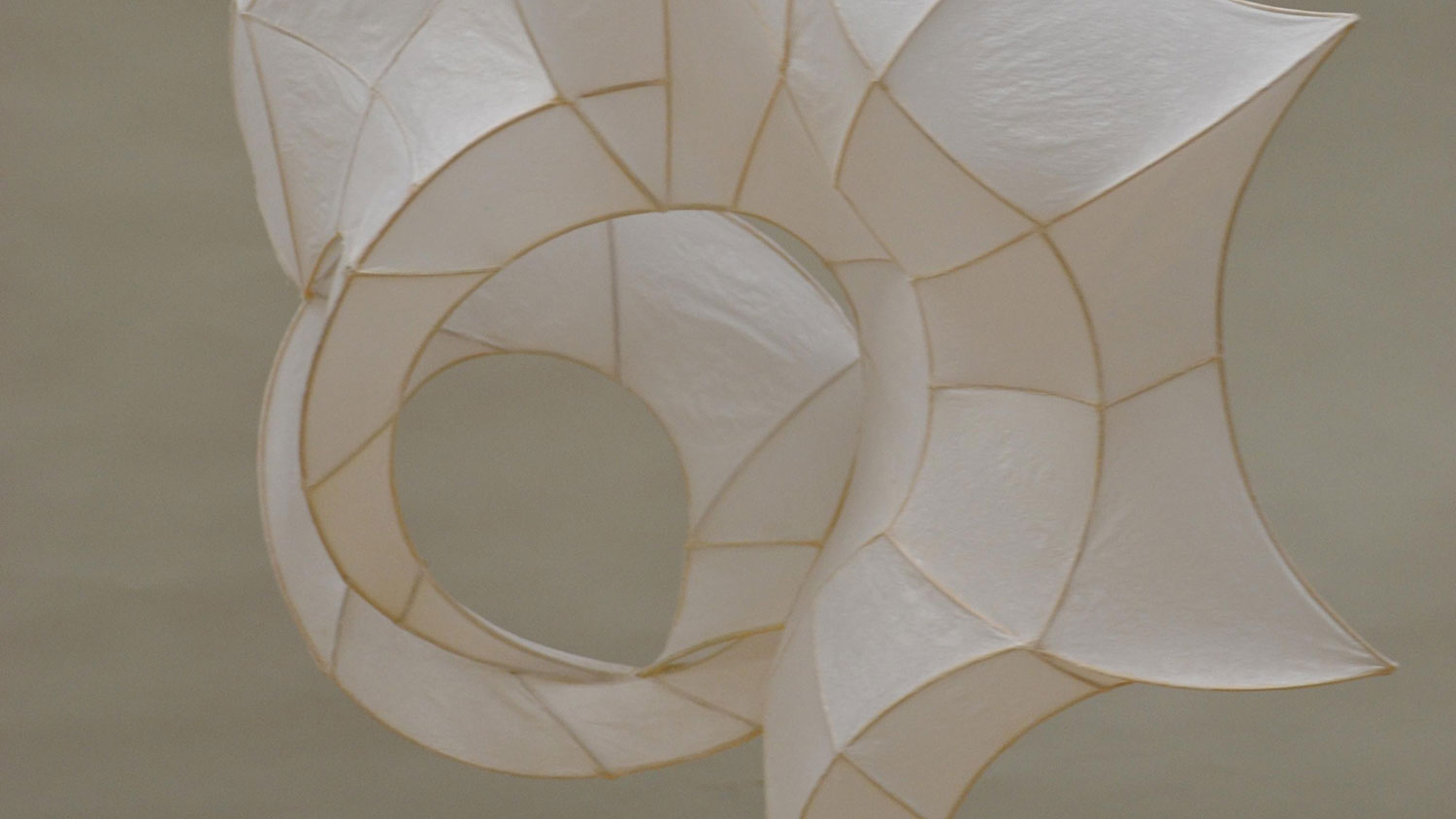 a form made from a frame covered in paper that looks like a seashell.