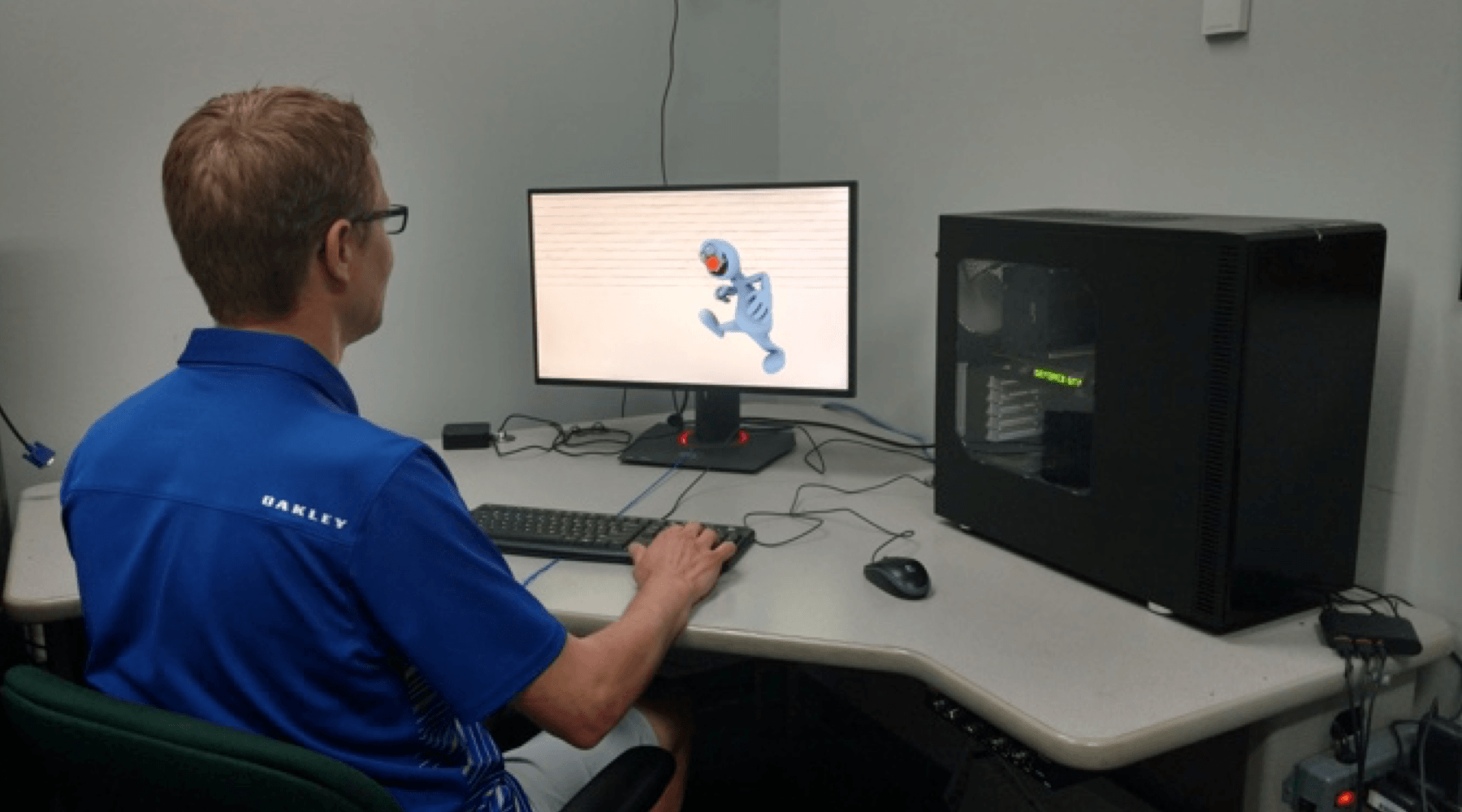 Man sitting at a desk, using a computer.