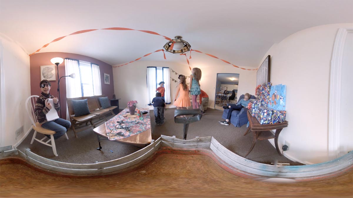 A panoramic photo of a room with children playing.