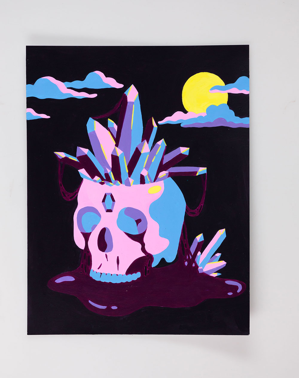 painting of a skull with crystals coming out of the top, in pink, blue, and purple.