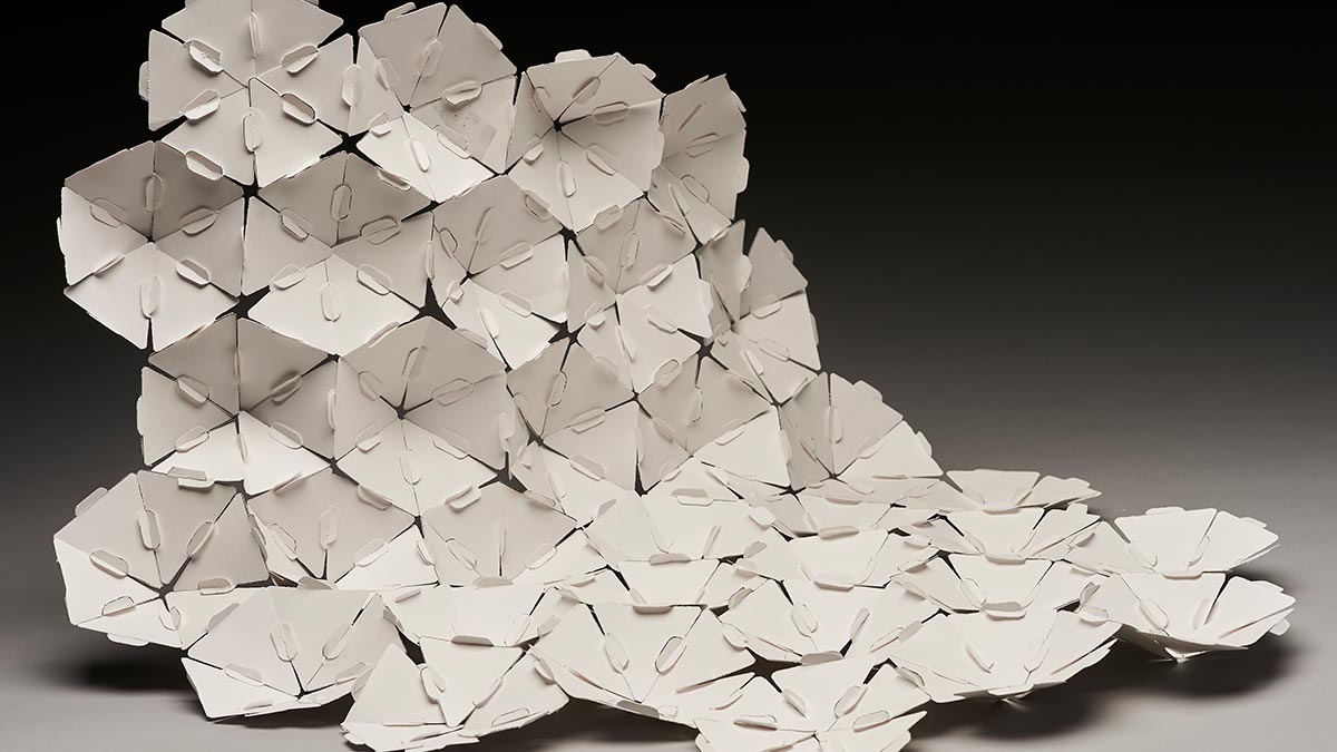 triangles of paper arranged into flower blooms, in a cascade.
